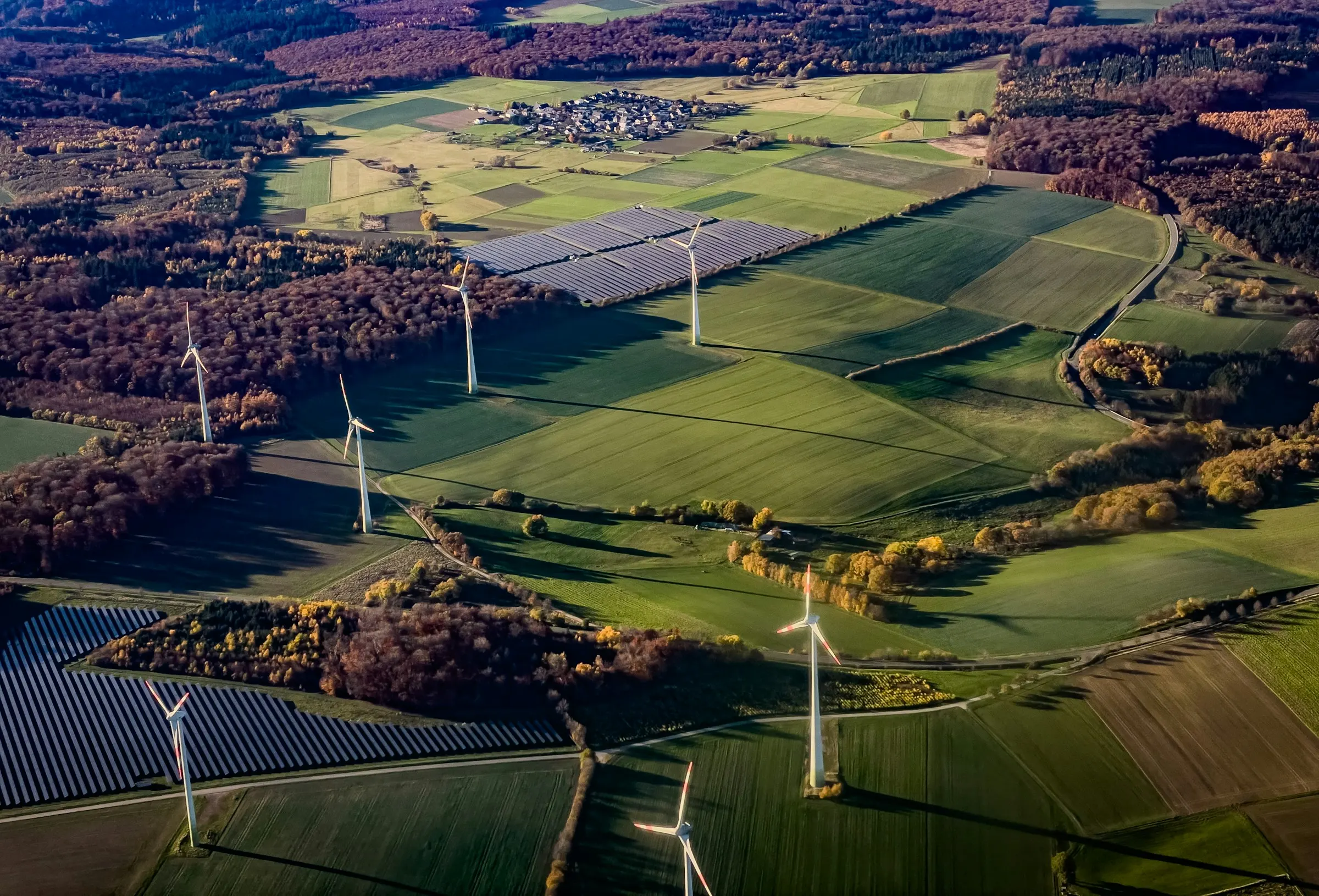 Wind turbines and solar panels across farmland